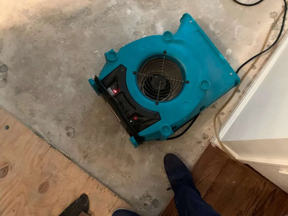 Air mover drying subfloor during Leak Detection & Repair in North Logan